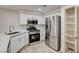 Modern kitchen features stainless appliances, white cabinetry, and a pantry for ample storage at 3400 Cabana Dr # 1048, Las Vegas, NV 89122