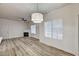 Open living area featuring modern light fixture, cozy fireplace, ceiling fan, and natural light at 3400 Cabana Dr # 1048, Las Vegas, NV 89122
