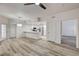 Open concept living space with wood flooring and adjacent kitchen with breakfast bar at 3400 Cabana Dr # 1048, Las Vegas, NV 89122