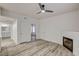 Living room featuring modern ceiling fan, fireplace, and entry to the kitchen and bathroom at 3400 Cabana Dr # 1048, Las Vegas, NV 89122