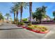 Black Horse community street view with manicured landscaping, palm trees, and beautiful buildings at 3400 Cabana Dr # 1048, Las Vegas, NV 89122