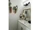 Elegant powder room featuring modern fixtures, marble countertop, and decorative wall art at 3791 Soplo Rd, Pahrump, NV 89048