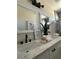 Elegant bathroom showcasing dual sinks, marble countertops, and decorative accents at 3791 Soplo Rd, Pahrump, NV 89048