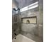 Modern gray bathroom with a shower featuring a built-in shelf and sleek fixtures at 3791 Soplo Rd, Pahrump, NV 89048