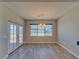 A dining area features wood floors, large windows, and a stylish chandelier at 3791 Soplo Rd, Pahrump, NV 89048