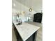 Modern kitchen features a large island with marble countertops and pendant lighting at 3791 Soplo Rd, Pahrump, NV 89048