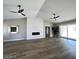 Spacious living room with wood flooring, fireplace, and sliding glass door to backyard at 3791 Soplo Rd, Pahrump, NV 89048