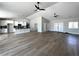Open-concept living area with wood floors, white cabinets, and an island with pendant lights at 3791 Soplo Rd, Pahrump, NV 89048