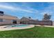 Inviting backyard featuring a sparkling pool, lush lawn, and a brick privacy wall at 394 Lombardy Cir, Henderson, NV 89015