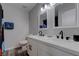 Modern bathroom boasts double sinks, white cabinets, and a neutral wall color with a decorative mirror at 394 Lombardy Cir, Henderson, NV 89015