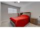 Cozy bedroom with a full-sized bed, a nightstand, and a window providing natural light at 394 Lombardy Cir, Henderson, NV 89015