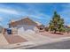 Single-story home with low maintenance desert landscaping and a two-car garage at 394 Lombardy Cir, Henderson, NV 89015