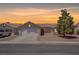 Charming single-story home with a well-maintained front yard and a two-car garage at sunset at 394 Lombardy Cir, Henderson, NV 89015