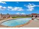 Inviting backyard pool featuring a rock waterfall, lounge chairs, and desert landscaping at 394 Lombardy Cir, Henderson, NV 89015