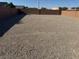Empty backyard with a gravel base and a brick privacy wall at 411 Hellebores Ave, North Las Vegas, NV 89084