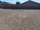 Spacious backyard featuring a stone ground cover with a view of the property's brick perimeter wall at 411 Hellebores Ave, North Las Vegas, NV 89084