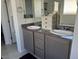Bathroom with a double sink vanity featuring grey cabinets and granite countertops at 411 Hellebores Ave, North Las Vegas, NV 89084