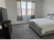 Bedroom with grey carpet, tv atop the dresser, and a window with privacy blinds at 411 Hellebores Ave, North Las Vegas, NV 89084