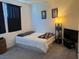 Cozy carpeted bedroom with a bed, bedside tables, and natural lighting from the window at 411 Hellebores Ave, North Las Vegas, NV 89084