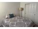 Comfortable bedroom features a bed, floor lamp, and large closet at 411 Hellebores Ave, North Las Vegas, NV 89084