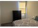 Bright bedroom featuring a window, dresser and natural lighting at 411 Hellebores Ave, North Las Vegas, NV 89084