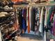 Spacious walk-in closet featuring ample shoe storage and plenty of hanging clothing at 411 Hellebores Ave, North Las Vegas, NV 89084