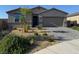 Charming single-story home with xeriscaped front yard and paver driveway, presenting modern curb appeal at 411 Hellebores Ave, North Las Vegas, NV 89084