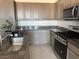 Functional kitchen space with sink, stove, and ample counter space for food preparation at 411 Hellebores Ave, North Las Vegas, NV 89084