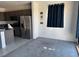 Open-concept living room off kitchen with gray cabinets and stainless steel appliances at 411 Hellebores Ave, North Las Vegas, NV 89084
