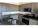 A well-equipped kitchen with granite countertops, stainless steel appliances, and plenty of storage at 411 Hellebores Ave, North Las Vegas, NV 89084