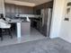 Well-lit kitchen with stainless steel appliances, breakfast bar, and ample cabinet space at 411 Hellebores Ave, North Las Vegas, NV 89084