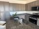 Well-lit kitchen with stainless steel appliances, granite countertops, and lots of cabinet space at 411 Hellebores Ave, North Las Vegas, NV 89084