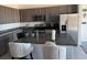 Modern kitchen with granite countertops, stainless steel appliances, and an island with seating at 411 Hellebores Ave, North Las Vegas, NV 89084