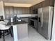 Open kitchen featuring stainless steel appliances, ample storage, and island with counter seating at 411 Hellebores Ave, North Las Vegas, NV 89084
