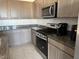 Kitchen featuring stainless steel appliances and ample counter space for cooking needs at 411 Hellebores Ave, North Las Vegas, NV 89084
