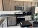A modern kitchen featuring granite counters, stainless appliances, and lots of storage space at 411 Hellebores Ave, North Las Vegas, NV 89084