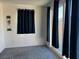 Carpeted living room featuring natural light and a sliding glass door leading to the exterior at 411 Hellebores Ave, North Las Vegas, NV 89084
