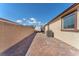 Paver patio and side yard alongside the home with a privacy wall and desert landscaping at 4510 Rubious Ave, North Las Vegas, NV 89084