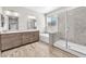 Bathroom with double vanity, soaking tub, and glass-enclosed shower at 4510 Rubious Ave, North Las Vegas, NV 89084
