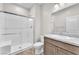 Modern bathroom featuring a glass-enclosed shower, granite counters, and neutral tile flooring at 4510 Rubious Ave, North Las Vegas, NV 89084