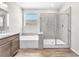 Modern bathroom with a combined tub and shower, wood-style tile flooring, and granite counters at 4510 Rubious Ave, North Las Vegas, NV 89084