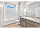 Bright bathroom featuring wood look floors, a shower-tub combo and a granite-look vanity at 4510 Rubious Ave, North Las Vegas, NV 89084