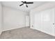 Bright bedroom featuring gray carpet, white trim and an accessible closet and ceiling fan at 4510 Rubious Ave, North Las Vegas, NV 89084