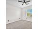 Bright bedroom featuring gray carpet, white walls, and a ceiling fan and a modern window at 4510 Rubious Ave, North Las Vegas, NV 89084