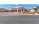 Charming single-story home with a three-car garage, stone accents, and well-maintained landscaping at 4510 Rubious Ave, North Las Vegas, NV 89084