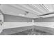 Spacious garage with epoxy flooring, white walls and door to the home at 4510 Rubious Ave, North Las Vegas, NV 89084