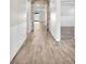 Hallway with wood-style floors, wainscoting, and stone archway to living area at 4510 Rubious Ave, North Las Vegas, NV 89084