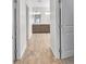 Bright hallway showcasing wood-style floors and leading to a bathroom with dual sinks at 4510 Rubious Ave, North Las Vegas, NV 89084