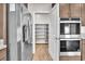 Modern kitchen featuring stainless steel appliances and a walk-in pantry for ample storage at 4510 Rubious Ave, North Las Vegas, NV 89084