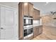 Modern kitchen featuring stainless steel double oven, granite counters and wood-look tile flooring at 4510 Rubious Ave, North Las Vegas, NV 89084